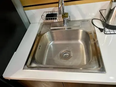 a stainless steel sink in a kitchen counter at Makati Ayala luxury Stylish Uncle Sam condo Gym Swim Park 300 Mb 2641 in Manila