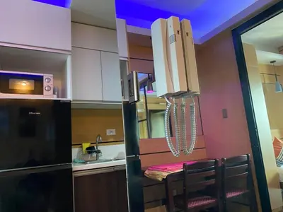 a small kitchen with a table and a sink at Makati Ayala luxury Stylish Uncle Sam condo Gym Swim Park 300 Mb 2641 in Manila