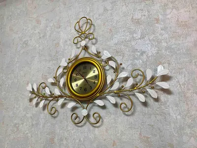 a gold clock on a wall with white flowers at Makati Broadway Bliss Golden spot Gym Swim Park 300 Mbps 1940 in Manila
