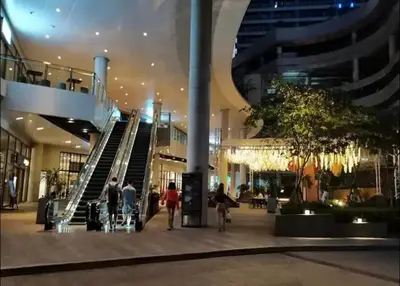 a group of people walking in a shopping mall at Makati Broadway Bliss Golden spot Gym Swim Park 300 Mbps 1940 in Manila