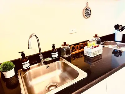 a kitchen counter with a sink in a kitchen at High Rise Haven in Makati with Balcony and View in Manila