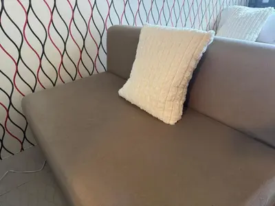 a couch with a pillow on top of it at High Rise Haven in Makati with Balcony and View in Manila
