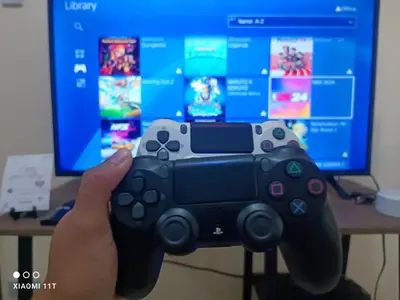 a person holding a video game controller in front of a computer monitor at 1 BEDROOM Staycation in Manila