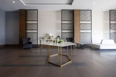 a room with a table and chairs and a couch at 1 BEDROOM Staycation in Manila