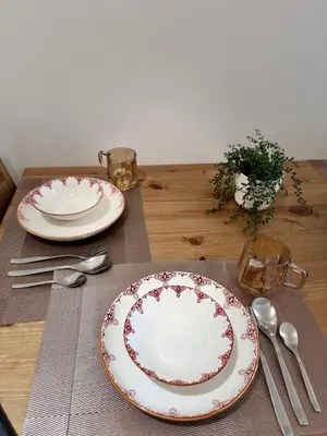 a table with two plates and silverware on it at Hearth of Ember 2 at Shore 3 Residences in Manila