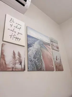 a wall with pictures on it with a sign on it at Hearth of Ember 2 at Shore 3 Residences in Manila