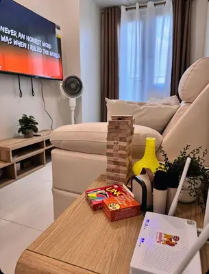a living room with a couch and a table at Hearth of Ember 2 at Shore 3 Residences in Manila