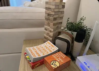 a pile of books sitting on a table next to a bed at Hearth of Ember 2 at Shore 3 Residences in Manila