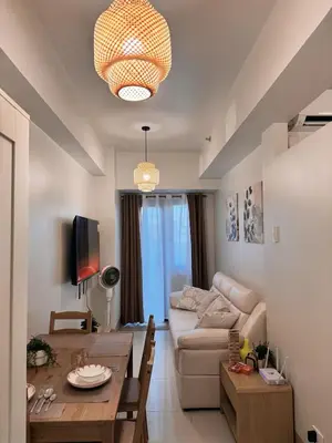a living room with a couch and a table at Hearth of Ember 2 at Shore 3 Residences in Manila