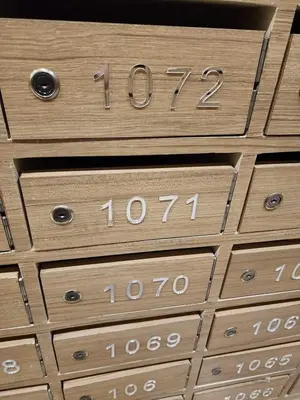 a bunch of wooden drawers with numbers on them at Niereys Suite 1071 in Manila