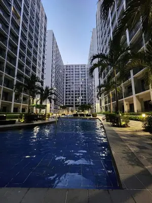 a large swimming pool in a city with tall buildings at Niereys Suite 1071 in Manila