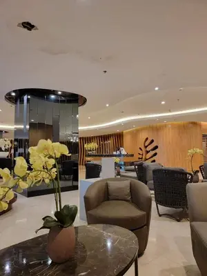 a lobby with a couch and a chair and a table at Niereys Suite 1071 in Manila