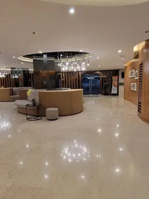 a lobby with a large lobby with chairs and tables at Niereys Suite 1071 in Manila