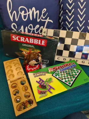 a table with a board game and a box of snacks at Niereys Suite 1071 in Manila