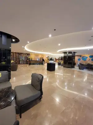 a lobby with a chair in the middle of a building at Niereys Suite 1071 in Manila