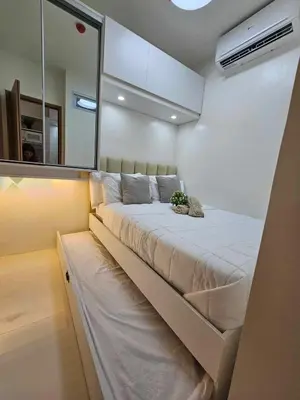 a large bed in a room with a mirror at Shore 3 Tower 4 Amenity View Pasay in Manila