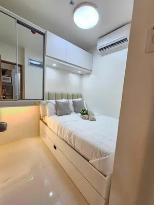 a bedroom with a bed with a plant on it at Shore 3 Tower 4 Amenity View Pasay in Manila