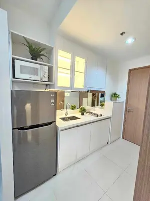 a kitchen with a stainless steel refrigerator and a microwave at Shore 3 Tower 4 Amenity View Pasay in Manila