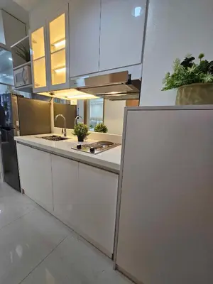 a kitchen with white cabinets and a counter top at Shore 3 Tower 4 Amenity View Pasay in Manila