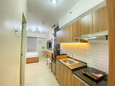 a kitchen with a sink and a counter top at cozy studio unit near airport in Manila