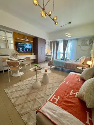 a large room with a bed and a living room at Chic Staycation with Balcony,few step in venice mall in Manila