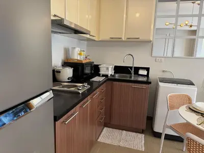 a kitchen with a sink and a counter top at Chic Staycation with Balcony,few step in venice mall in Manila