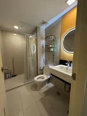 a bathroom with a toilet and a sink at Chic Staycation with Balcony,few step in venice mall in Manila