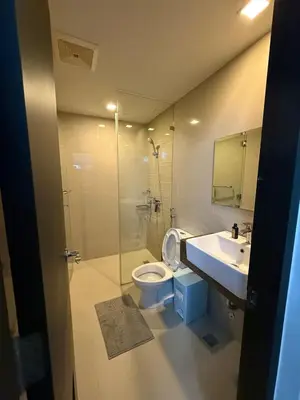 a bathroom with a toilet and a sink and a shower at Luxurious Studio Unit in Salcedo in Manila