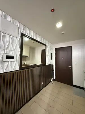 a hallway with a mirror and a door in a room at Luxurious Studio Unit in Salcedo in Manila