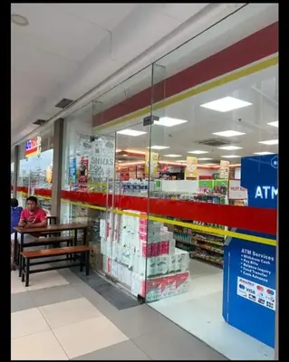 a person sitting on a bench in a store at Shore Residence 1 Bedroom Staycation in Manila
