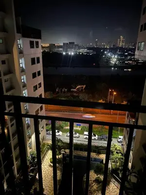 a view of a city at night from a balcony at Shore Residence 1 Bedroom Staycation in Manila