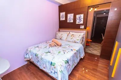 a small bedroom with a bed in a room at Chic Floating Penthouse Makati Gym Air condo gym swim park 300MB in Manila