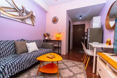 a living room with a couch and a table at Chic Floating Penthouse Makati Gym Air condo gym swim park 300MB in Manila
