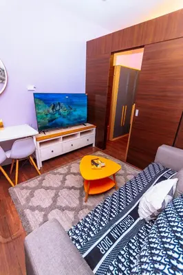 a living room with a couch and a large aquarium at Chic Floating Penthouse Makati Gym Air condo gym swim park 300MB in Manila