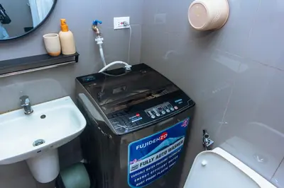 a small bathroom with a toilet and a sink at Chic Floating Penthouse Makati Gym Air condo gym swim park 300MB in Manila