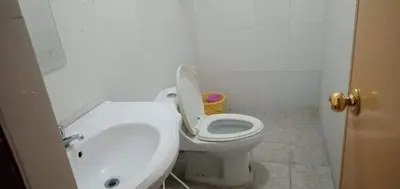 a bathroom with a toilet with the lid up at Asia Novo Boutique Hotel - Cabuyao Laguna in Cabuyao