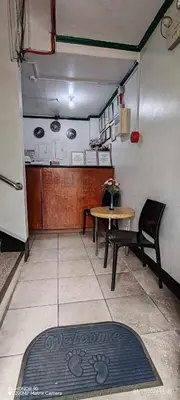 a kitchen with a table and a table and chairs at Asia Novo Boutique Hotel - Cabuyao Laguna in Cabuyao