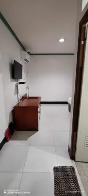 a room with a table and a tv on a wall at Asia Novo Boutique Hotel - Cabuyao Laguna in Cabuyao