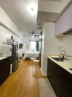 a kitchen with a sink and a bed in a room at Studio condo near Pobla Makati in Manila
