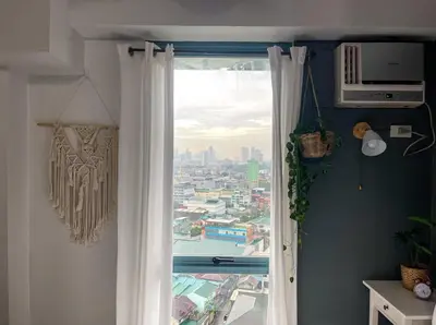 a window with a view of a city at Studio condo near Pobla Makati in Manila