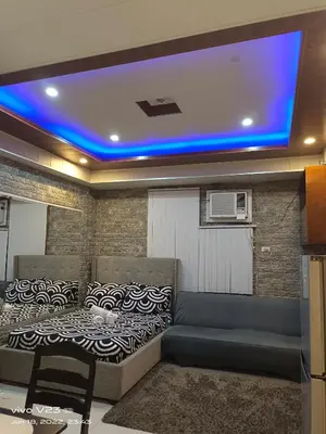 a room with a bed and a couch in it at Nethcondo in Manila