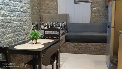 a small kitchen with a table and a couch at Nethcondo in Manila