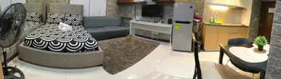 a kitchen and a living room with a couch and a kitchen at Nethcondo in Manila