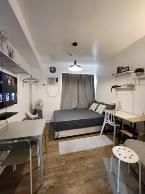a bedroom with a bed and a desk in a room at TheMudroomStyle ideal WFH near St Benedict Parish in Silang
