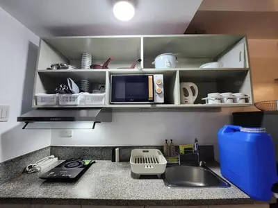 a kitchen counter with a sink and a microwave at TheMudroomStyle ideal WFH near St Benedict Parish in Silang