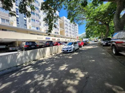 a street with cars parked in front of a building at TheMudroomStyle ideal WFH near St Benedict Parish in Silang
