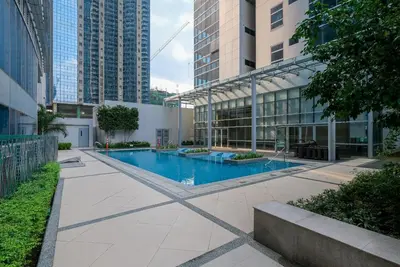 a swimming pool in the middle of a building at Cozy 3 Bedroom in Uptown Parksuites - Near Mall, Restaurants and Supermarket in Manila