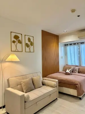 a living room with a couch and a bed at ElixirStaycation at Knightsbridge Residences in Manila