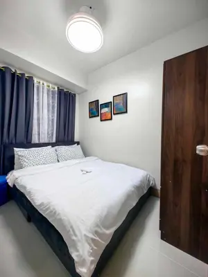 a bedroom with a large bed in a room at Luxurious Condo Near SM MOA in Manila