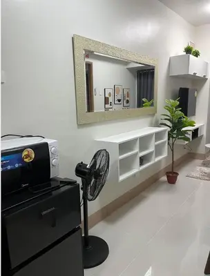 a white room with a mirror and a fan at Luxurious Condo Near SM MOA in Manila